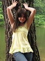 Free Stock Photo: A beautiful young girl posing against a tree a lake