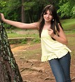Free Stock Photo: A beautiful young girl with a necklace posing against a tree