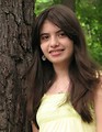 Free Stock Photo: A beautiful young girl posing against a tree
