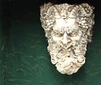 Free Stock Photo: A statue of a bearded man on a wall