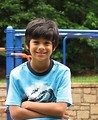 Free Stock Photo: A young latino boy posing by a playground