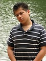 Free Stock Photo: A young latino man posing outdoors by a lake