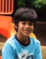 Free Stock Photo: A young latino boy posing by a playground