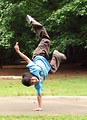 Free Stock Photo: A young latino boy doing a handstand in a park