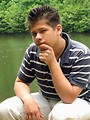 Free Stock Photo: A young latino man posing outdoors by a lake