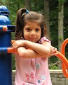 Free Stock Photo: A cute young latina girl posing on a playground