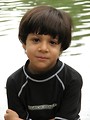 Free Stock Photo: A young latino boy posing by a lake