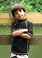 Free Stock Photo: A young latino boy posing by a lake