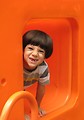 Free Stock Photo: A young latino boy with an angry expression playing on a playground