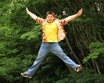 Free Stock Photo: A latino teen boy in a colorful shirt jumping outdoors