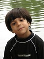 Free Stock Photo: A young latino boy posing by a lake