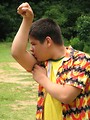 Free Stock Photo: A latino teen boy in a colorful shirt showing off his muscles