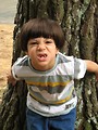 Free Stock Photo: A young latino boy with an angry expression posing by a lake