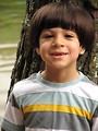 Free Stock Photo: A young latino boy posing by a lake