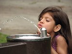 Free Stock Photo: A cute young latina girl drinking from a water fountain