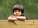 Free Stock Photo: A young latino boy posing by a lake