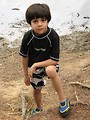 Free Stock Photo: A young latino boy posing by a lake