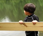 Free Stock Photo: A young latino boy looking over a lake