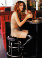 Free Stock Photo: A beautiful woman sitting at a bar with a drink