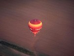 Free Stock Photo: A hot air balloon flying over a field