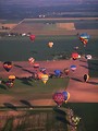 Free Stock Photo: Hot air balloons flying over a field.