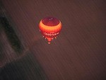 Free Stock Photo: A hot air balloon flying over a field