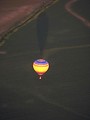 Free Stock Photo: A hot air balloon flying over a field.
