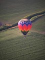 Free Stock Photo: A hot air balloon flying over a field