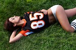 Free Stock Photo: A beautiful girl in a football jersey lying in the grass