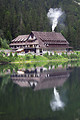 Free Stock Photo: A chalet at the base of a mountain reflecting in water