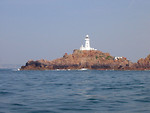Free Stock Photo: A white light house on a small rock island