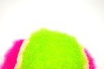 Free Stock Photo: A pink and green tennis ball isolated on a white background