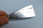 Free Stock Photo: A hand holding a putty knife isolated on a white background