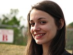 Free Stock Photo: A teenage girl smiling with a field in the background.