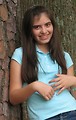 Free Stock Photo: A beautiful latina teen girl posing against a tree