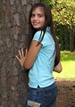 Free Stock Photo: A beautiful latina teen girl posing against a tree