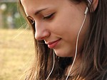 Free Stock Photo: A teenage girl listening to a music player.