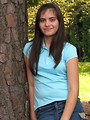 Free Stock Photo: A beautiful latina teen girl posing against a tree