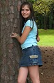 Free Stock Photo: A beautiful latina teen girl posing against a tree