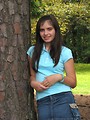 Free Stock Photo: A beautiful latina teen girl posing against a tree