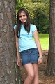 Free Stock Photo: A beautiful latina teen girl posing against a tree