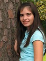 Free Stock Photo: A beautiful latina teen girl posing against a tree