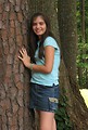 Free Stock Photo: A beautiful latina teen girl posing against a tree