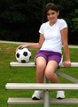 Free Stock Photo: A beautiful teen latina girl posing on bleachers with a soccer ball