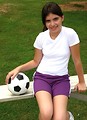 Free Stock Photo: A beautiful teen latina girl posing on bleachers with a soccer ball