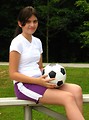 Free Stock Photo: A beautiful teen latina girl posing on bleachers with a soccer ball