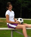 Free Stock Photo: A beautiful teen latina girl posing on bleachers with a soccer ball