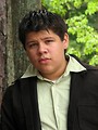 Free Stock Photo: A teen latino boy posing outdoors by a tree