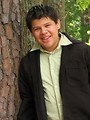 Free Stock Photo: A teen latino boy posing outdoors by a tree