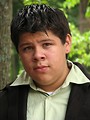 Free Stock Photo: A teen latino boy posing outdoors by a tree